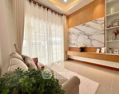 Elegant living room with modern decor and large windows for natural light.