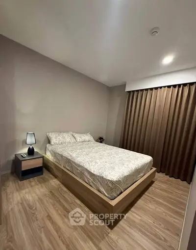 Cozy bedroom with modern decor and wooden flooring, perfect for relaxation.