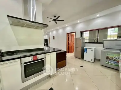 Modern kitchen with sleek appliances and open layout, featuring a stylish oven and ample storage space.