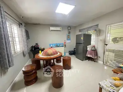 Spacious kitchen with modern appliances and wooden dining set, perfect for family gatherings.