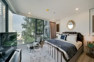 Luxurious bedroom with floor-to-ceiling windows and modern decor in urban high-rise.