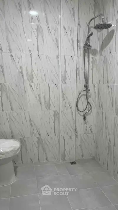 Modern bathroom with marble tiles and sleek shower design