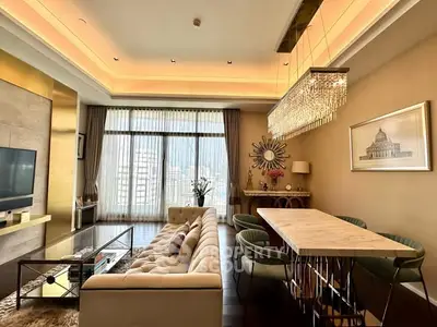 Luxurious living room with elegant chandelier and floor-to-ceiling windows offering stunning city views.