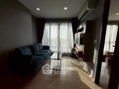 Modern living room with large windows and stylish furniture in a cozy apartment.