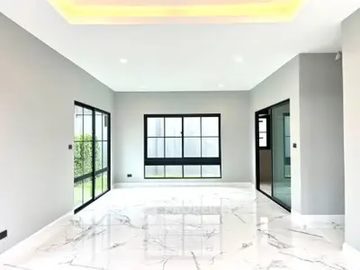 Spacious modern living room with marble flooring and large windows