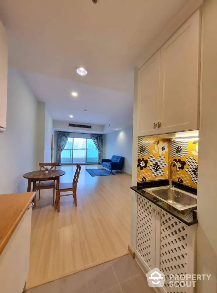 Spacious open-plan living room with modern kitchen and vibrant backsplash