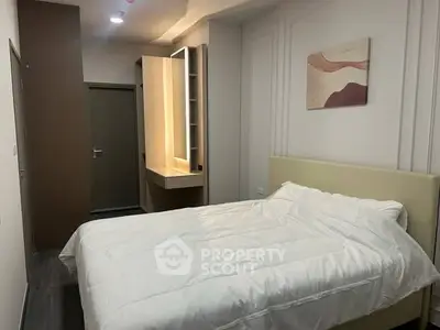 Modern bedroom with cozy bed and stylish decor in a contemporary apartment.
