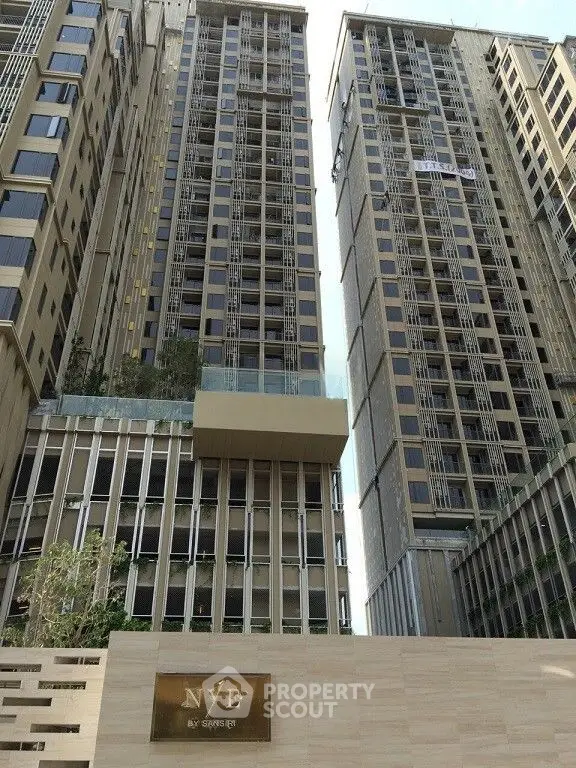 Luxurious high-rise building with modern architecture and elegant facade in urban setting.