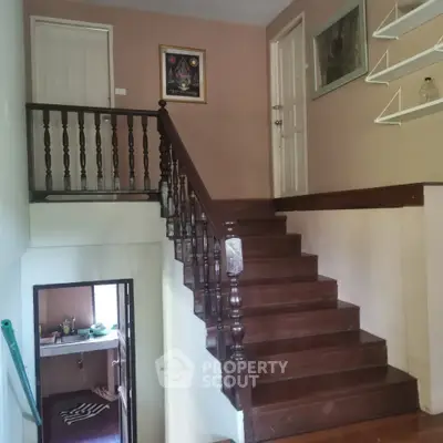 Charming wooden staircase with elegant railing in cozy home interior