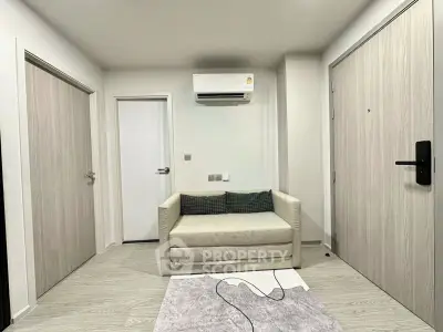 Modern living room with minimalist decor and air conditioning unit