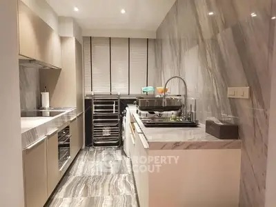 Modern kitchen with sleek marble countertops and stainless steel appliances in a cozy closed layout.
