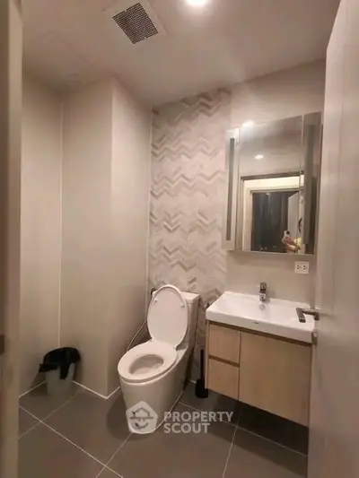 Modern bathroom with sleek design and elegant fixtures in a contemporary apartment.
