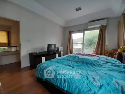 Cozy bedroom with balcony access and natural light