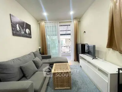 Cozy living room with modern gray sofa and balcony view