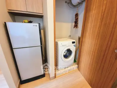 Modern kitchen corner with fridge and washing machine in compact layout