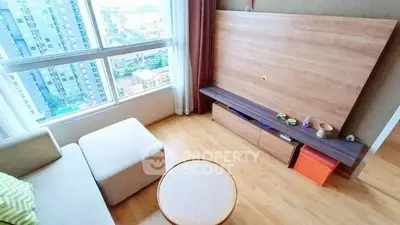 Bright living room with city view, modern furniture, and large window.