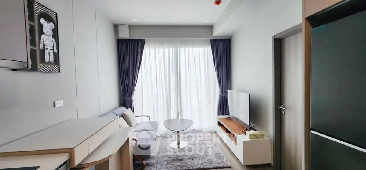 Modern living room with cozy sofa, TV, and large window with curtains