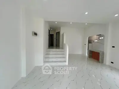 Spacious modern interior with elegant marble flooring and stylish lighting, perfect for contemporary living.
