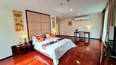 Luxurious bedroom with elegant decor and hardwood floors