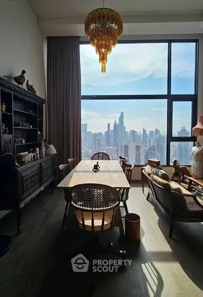 Luxurious dining room with stunning city skyline view and elegant chandelier.