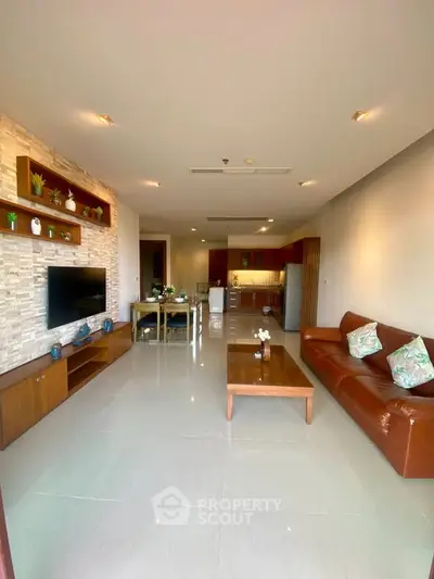 Spacious open-plan living room with modern kitchen and stylish decor