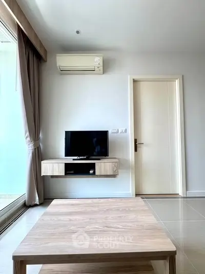Modern living room with wall-mounted TV and air conditioning unit