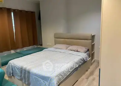 Cozy bedroom with modern decor and ample natural light