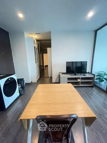 Modern living room with sleek wooden flooring and stylish furniture