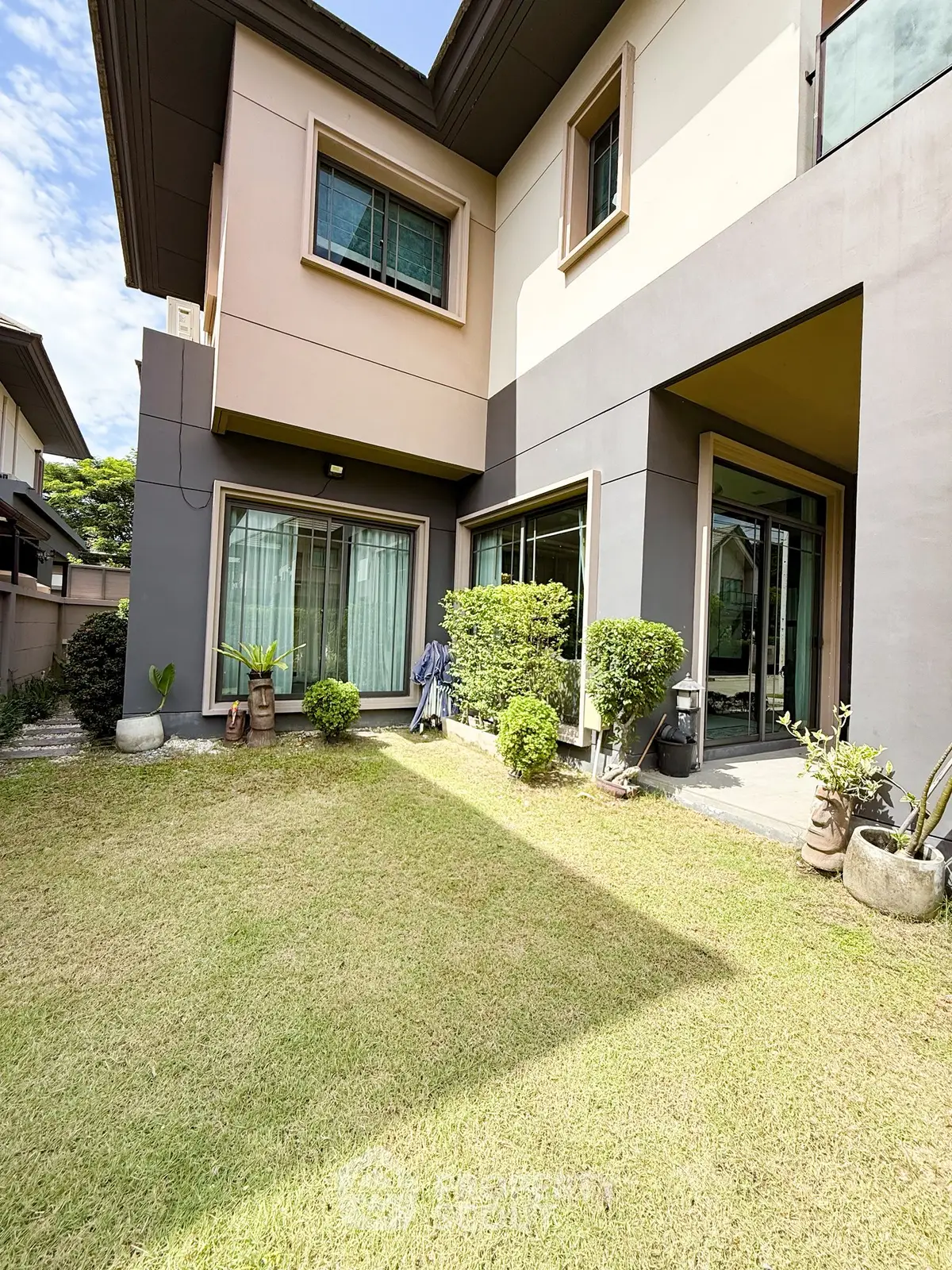 Spacious modern home with lush garden and large windows for natural light.