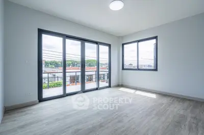 Spacious corner unit with large windows and modern flooring, offering abundant natural light and a great view.