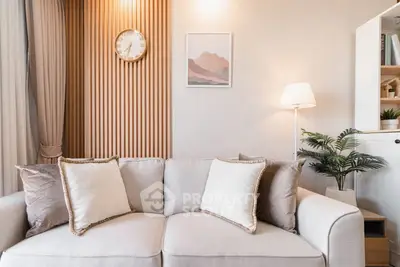 Stylish living room with modern decor and cozy sofa in elegant apartment.