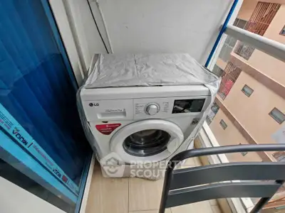 Compact balcony with washing machine and chair, ideal for urban living.