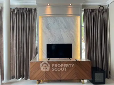 Elegant living room with modern TV stand and luxurious curtains