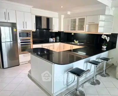 Modern kitchen with sleek black countertops and stainless steel appliances
