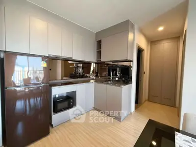 Modern kitchen with sleek cabinetry and built-in appliances in a stylish apartment.