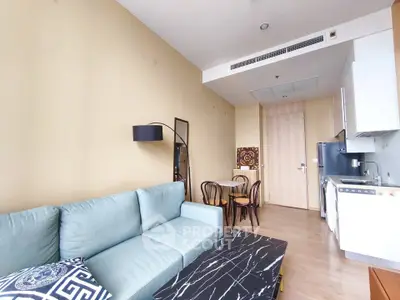 Modern living room with stylish furniture and open kitchen layout in a cozy apartment.