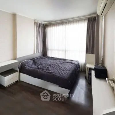 Cozy bedroom with modern furnishings and large window for natural light