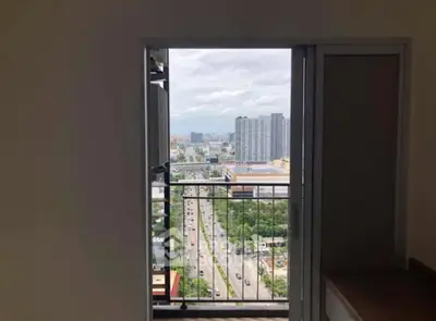 High-rise apartment balcony with stunning cityscape view and modern urban skyline.