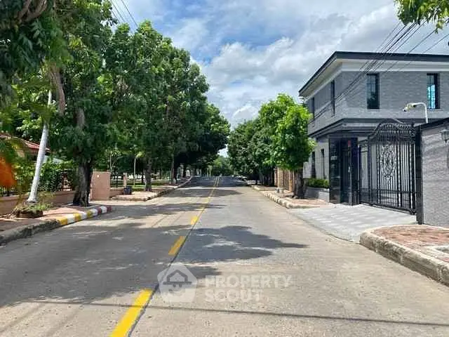 Charming suburban street view with modern house and lush greenery, perfect for tranquil living.