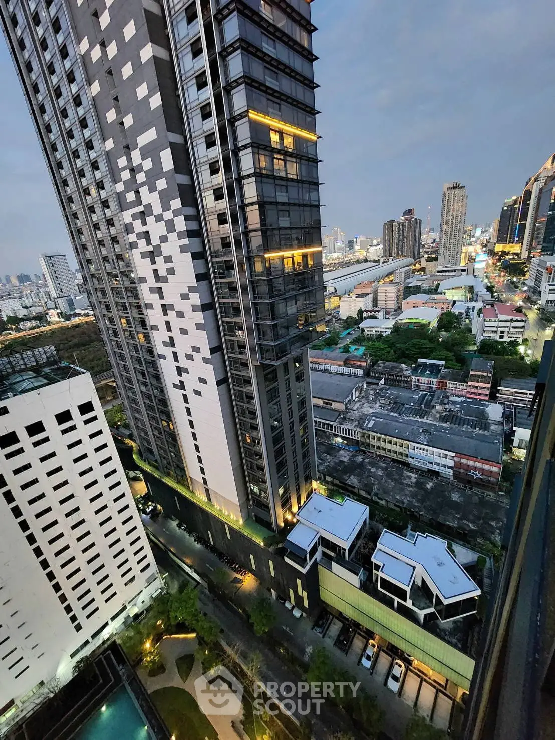 Stunning cityscape view from high-rise building balcony at dusk