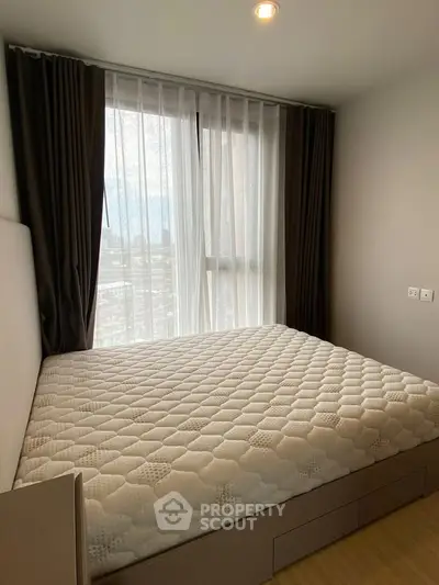 Cozy bedroom with large window and modern decor