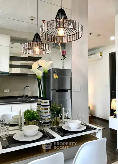 Modern kitchen with elegant dining setup and stylish lighting fixtures