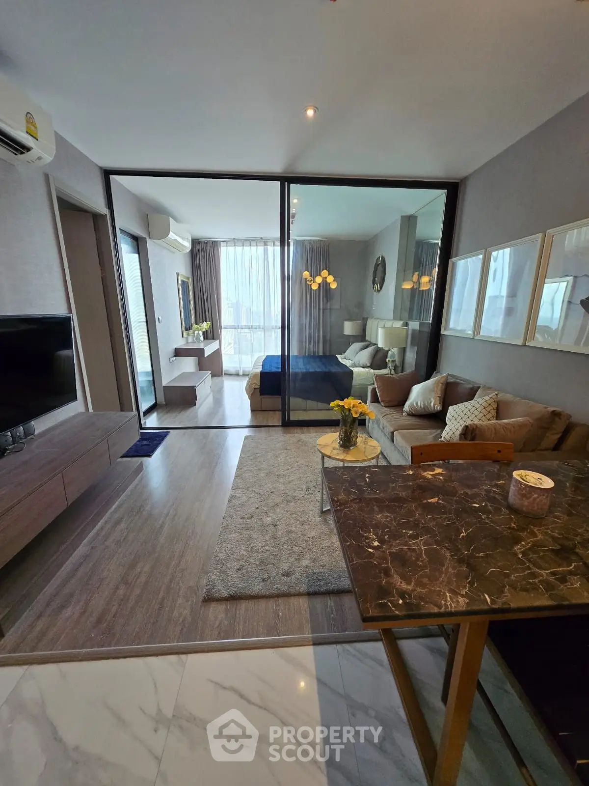 Modern open-plan living room with stylish decor and large windows