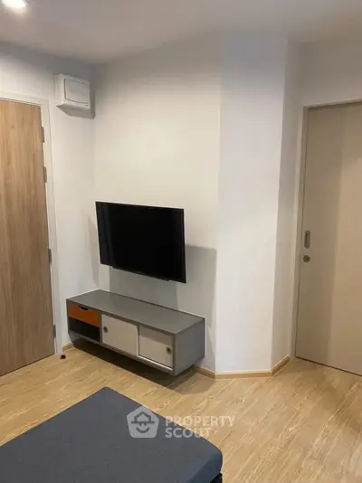 Modern living room with mounted TV and stylish storage unit