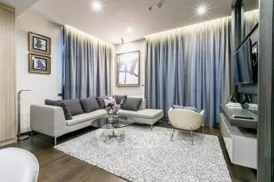 Modern living room with stylish decor, cozy seating, and elegant lighting.