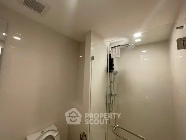 Modern bathroom with glass shower and sleek fixtures