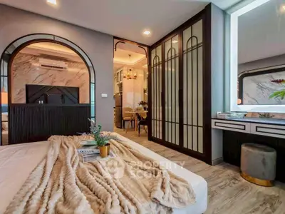 Luxurious bedroom with elegant decor and modern furnishings, featuring a cozy bed and stylish lighting.