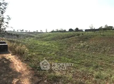 Expansive green land with potential for development, offering serene views and ample space for creative projects.