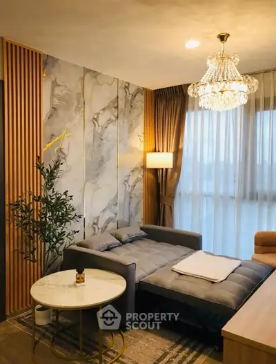 Luxurious living room with elegant chandelier and marble accent wall