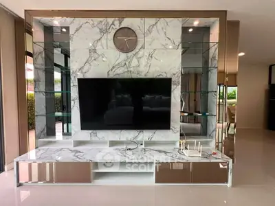 Luxurious living room with marble TV wall and sleek modern design